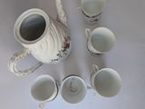 several cups and a teapot are arranged in a circle