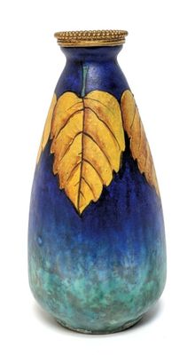 a blue vase with a yellow leaf design on it