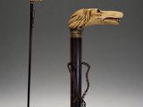an old cane with a lion head on it next to a cane