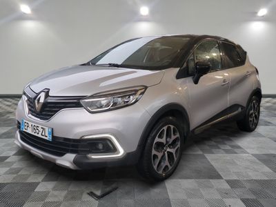 the front of a silver car parked on a checkered floor