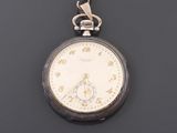 an antique pocket watch with a chain hanging from it ' s side