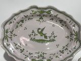 a plate with a bird on it sitting on a table