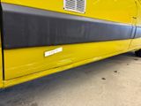 a yellow van with a sticker on the side of it