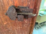 a close up of a door handle on a wooden door