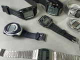 many different types of electronic watches on a table