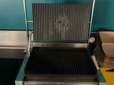 a grill that is sitting on a counter in a kitchen