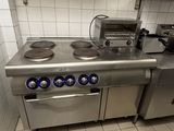 a kitchen with a stove, oven, and sink in it