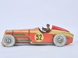 a red and yellow toy car with a man sitting in it