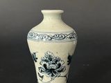 a blue and white vase sitting on a table