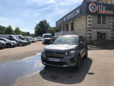 a car parked in front of a building with cars parked in front of it