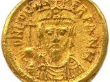 une pièce d'or à l'effigie d'un homme coiffé d'une couronne