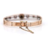an image of a close up of a bracelet on a white surface