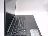 a laptop computer sitting on a table with a keyboard