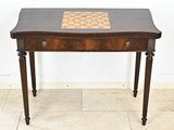 an old wooden table with a chess board on top of it