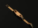 a close up of a gold watch on a black surface