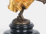 bronze statue of a woman holding a fan on a black base