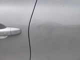 a close up of a door handle on a silver car