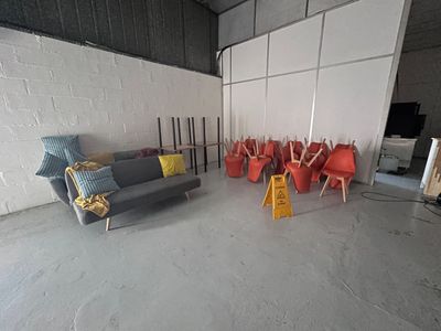 many chairs and a couch in a room with a white wall