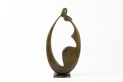 a bronze sculpture of a woman holding a bird on a white background
