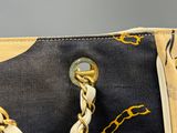 a close up of a purse with a chain on it