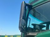 a green truck with a yellow arrow on the side of it