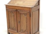 a small wooden cabinet with two doors and a drawer