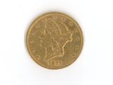 a gold coin on a white surface with a white background