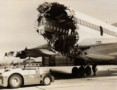 a large airplane that is sitting on the tarmac next to a truck