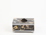 black and gold marbled box with a black bow on top