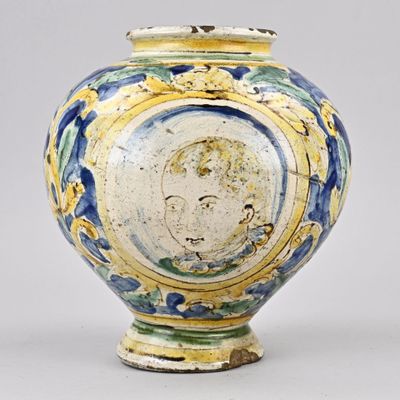 a blue and yellow vase with a picture of a man on it