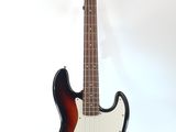 an electric bass guitar sitting on top of a stand on a white surface