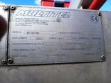 a close up of a metal sign on a machine