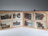 an open book with pictures of buildings and bridges on it