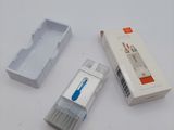 a toothbrush, toothpaste, and toothpaste holder on a table