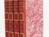 trois livres rouges superposés sur une surface blanche