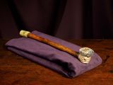 a pipe sitting on top of a purple cloth on a wooden table