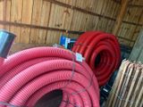 a bunch of red hoses that are on a table