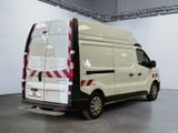 a white van with red stripes parked in a garage