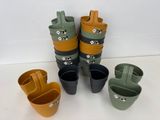 many pots that are sitting next to each other on the table
