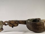 a wooden bowl with a handle on a white pedestal