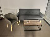 two chairs and a couch in a room with a window