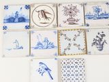 several blue and white tiles with birds and flowers on them