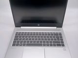 an open laptop computer sitting on top of a white table