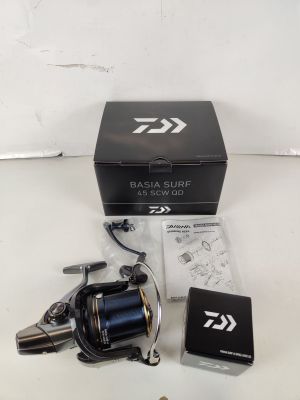 a close up of a fishing reel and a box on a table