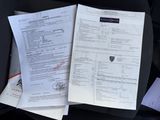 papers on the seat of a car with a black seat belt