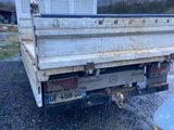 a white truck that is parked in the gravel