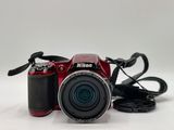 a red camera that is sitting on a white table