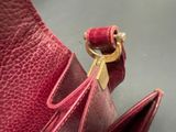 a red purse that has a gold key in it