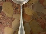 a spoon and a spoon rest on a table