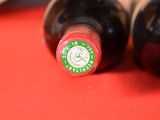 two bottles of wine that are sitting on a table